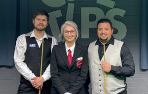 Daniel Womersley and Billy Castle stand with their cues either side of referee Claudia Ene.