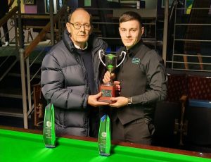 Ashley Carty holds the Jake Nicholson Trophy with Jake's father.