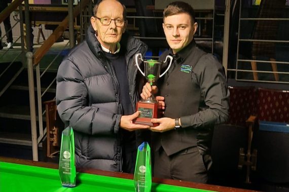 Ashley Carty holds the Jake Nicholson Trophy with Jake's father.