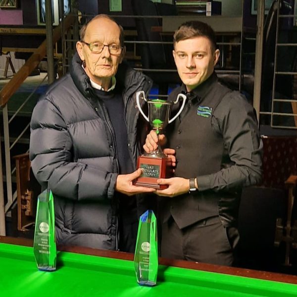 Ashley Carty holds the Jake Nicholson Trophy with Jake's father.