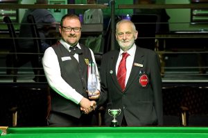 Rob Hall shakes tournament director Frank Bradley's hand and holds take home trophy.