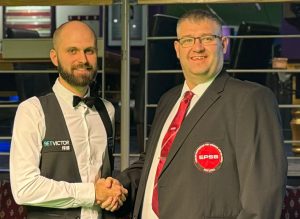 Steven Hallworth on the left shakes hands with tournament director James Chambers.