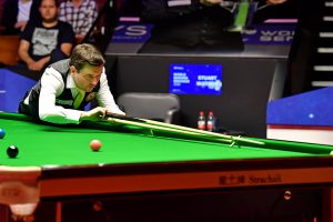 Stuart Watson plays a shot with the rest in his waistcoat at the Crucible Theatre.